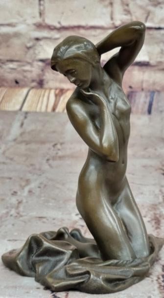 Grace in Repose Nude Bronze Female Figure: Grace in Repose Nude Bronze Female Figure A sensuous expression of elegance and quiet introspection, this exquisite bronze sculpture features a nude female figure posed gracefully on her knees. One ha