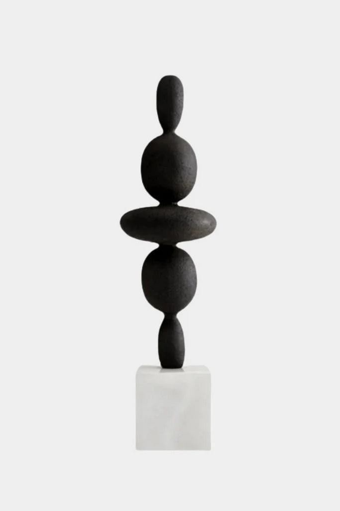 Abstract Stacked Wood Sculpture on White Base: Abstract Stacked Wood Sculpture on White Base A modern sculptural piece crafted from smooth, black-painted wood. It features a vertical stack of rounded, organically-shaped forms, each carefully balan