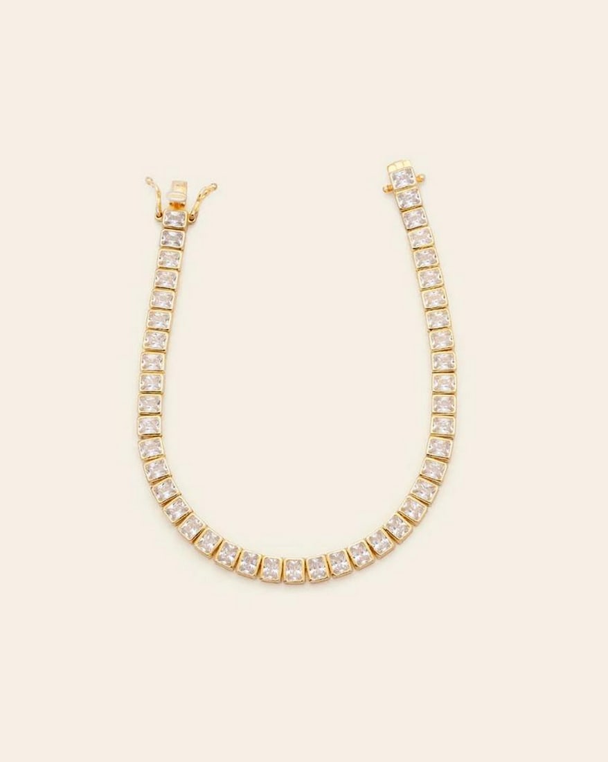 Emerald Cut CZ Stones Tennis Bracelet: Emerald Cut CZ Stones Tennis Bracelet This Emerald Cut CZ Stones Tennis Bracelet is a dazzling statement of elegance and refinement. Featuring a row of precisely cut cubic zirconia stones in a