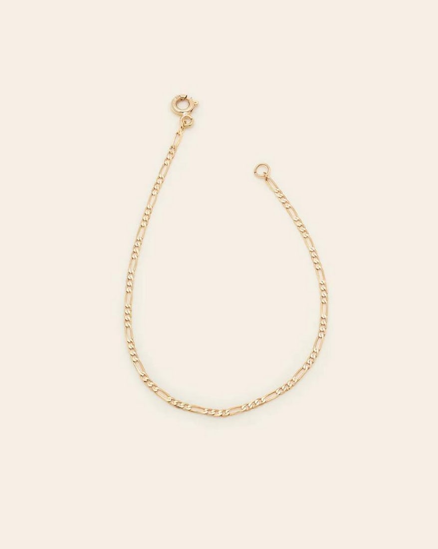 10k Solid Gold Figaro Chain Anklet: 10k Solid Gold Figaro Chain Anklet The Figaro Chain features a timeless design with understated elegance. This versatile anklet complements any look, adding the perfect touch of shine. Solid gold is d