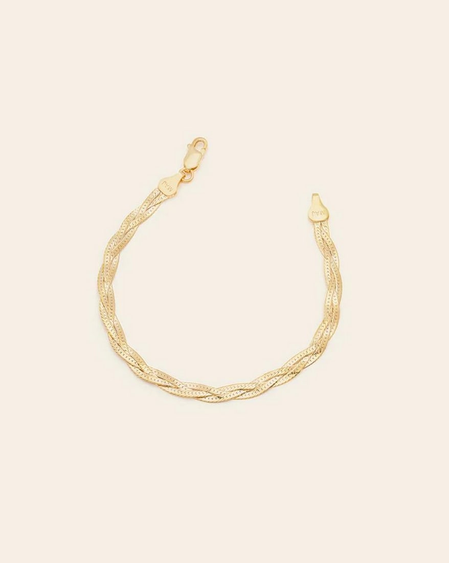 Gold Vermeil Braided Herringbone Bracelet: Gold Vermeil Braided Herringbone Bracelet A modern twist on a classic! Three herringbone chains are delicately intertwined to create a golden braid that dazzles on any wrist. The perfect, effortless a