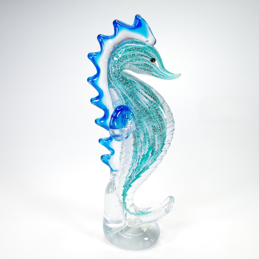 “Spirit of the Ocean?? Seahorse Glass Sculpture by Mirhò: “Spirit of the Ocean” Seahorse Glass Sculpture by Mirhò This hand-blown glass sculpture by Mirhò depicts a seahorse in a curved and upright form, emphasizing fluidity and balance. The piece 