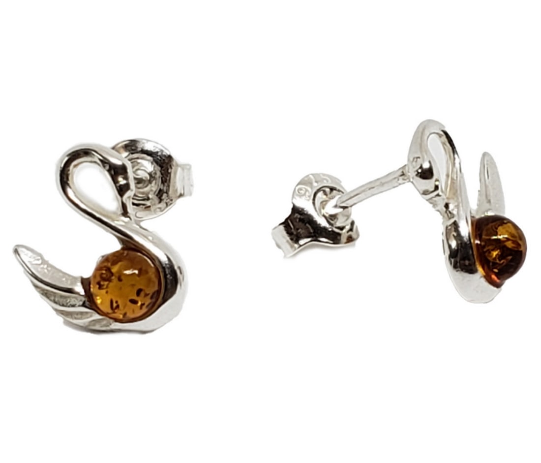 Swan Lake Amber Sterling Silver Stud Earrings: Swan Lake Amber Sterling Silver Stud Earrings The amber stones, with their warm hues reminiscent of the sun's golden glow, add a touch of natural splendor to the design. Set against the backdrop o