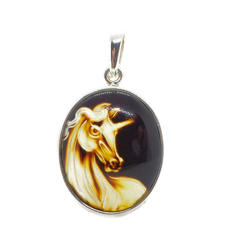 Carved Amber Reversed Intaglio Unicorn Cameo Pendant: Carved Amber Reversed Intaglio Unicorn Cameo Pendant This mesmerizing pendant showcases a reversed intaglio unicorn cameo, expertly carved into luminous amber. The intricate design captures the mythic
