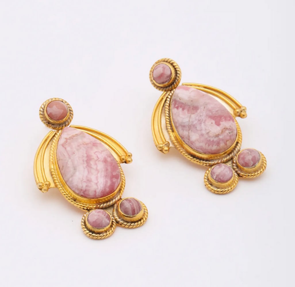 Rose Glow Rhodochrosite Studs: Rose Glow Rhodochrosite Studs These handcrafted earrings feature captivating rhodochrosite gemstones with rich pink and white marbling. Set in gold-plated sterling silver, they blend elegance and
