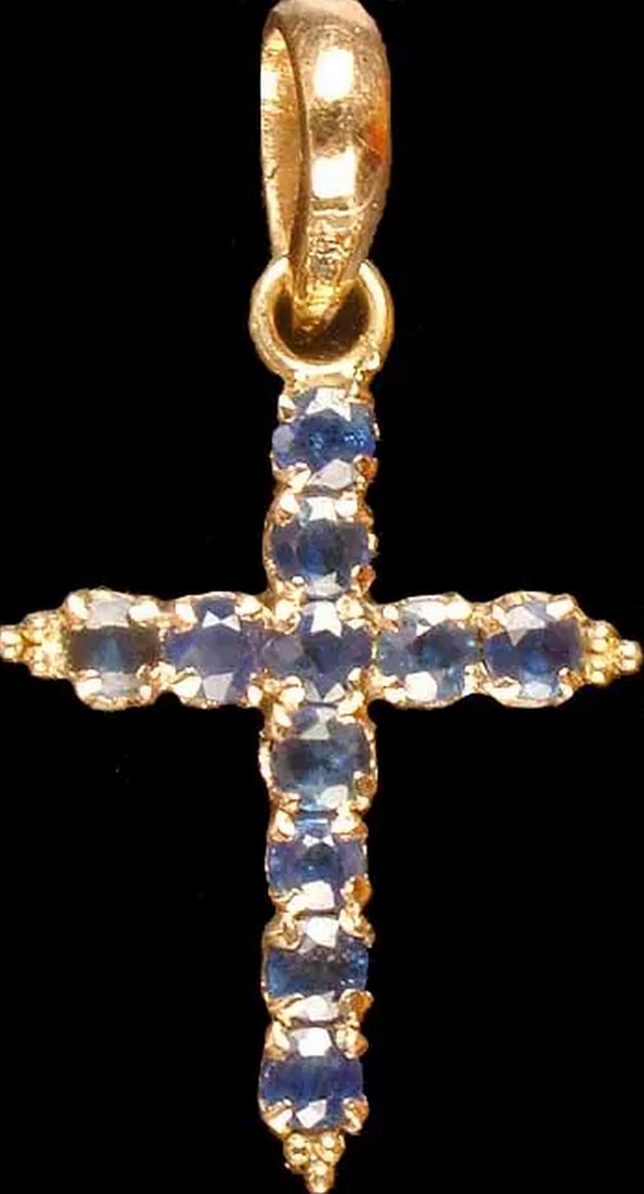 Eternal Light Sapphire Cross Pendant: Eternal Light Sapphire Cross Pendant The Eternal Light Sapphire Cross Pendant embodies faith, elegance, and timeless devotion. Crafted from 18K gold, its rich hue beautifully complements the deep blue