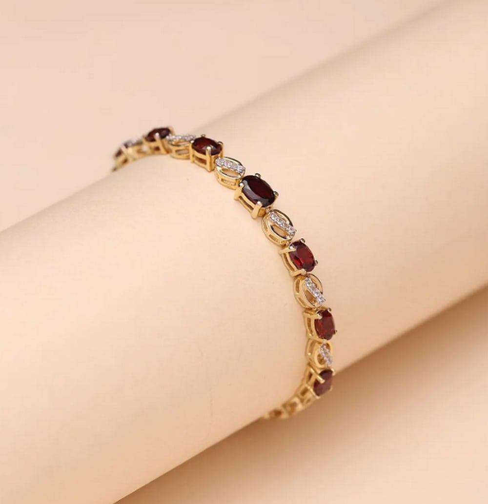 Fine-Cut Garnet Gemstone Bracelet in Sterling Silver – 8.2": Fine-Cut Garnet Gemstone Bracelet in Sterling Silver – 8.2" Elegant and timeless, this sterling silver bracelet features fine-cut garnets that radiate deep, rich red tones. At 8.2 inches, it