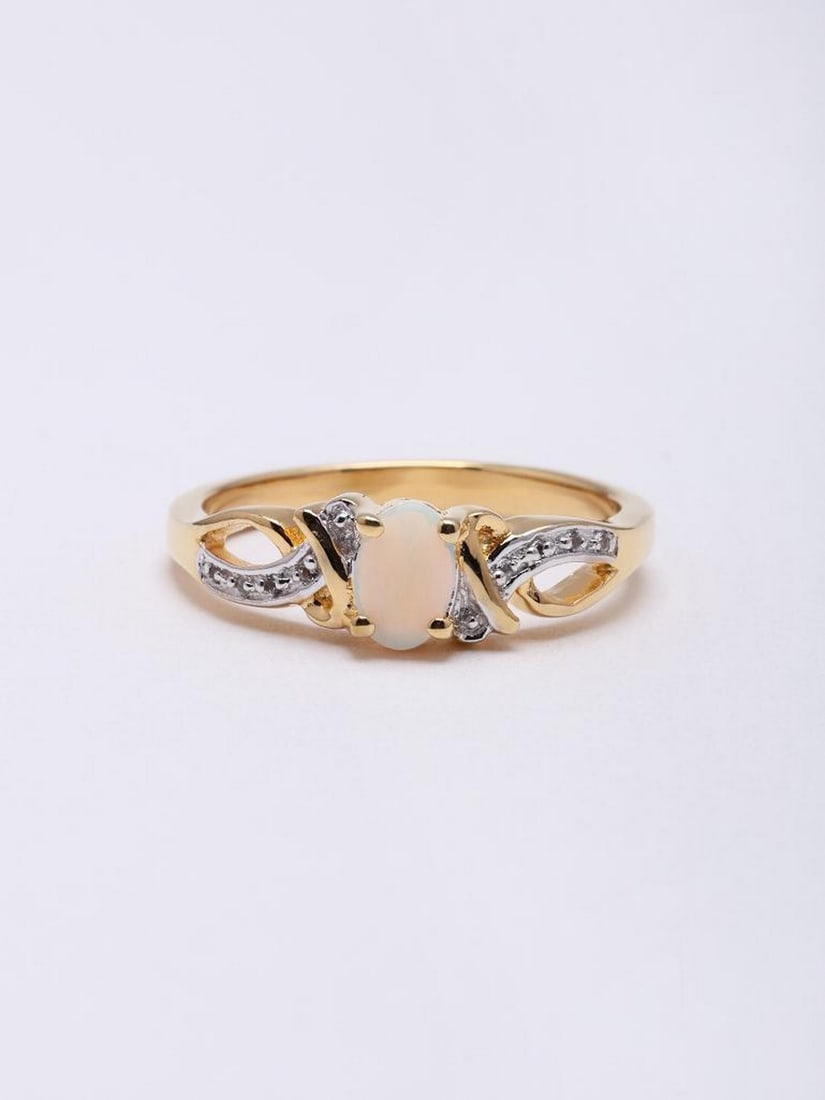 Sterling Silver Ring with Oval Ethiopian Opal: Sterling Silver Ring with Oval Ethiopian Opal This elegant ring features a smooth oval Ethiopian opal set in sterling silver, showcasing the stone’s natural iridescence and subtle play of colors.