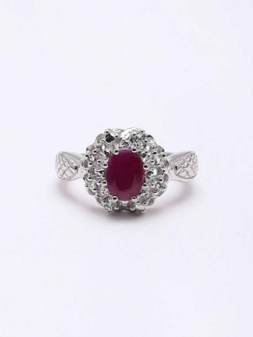 Floral Faceted Ruby Gemstone Ring: Floral Faceted Ruby Gemstone Ring This elegant ring features a richly faceted ruby at its center, framed by a delicate floral-inspired halo that adds brilliance and sophistication. Crafted in