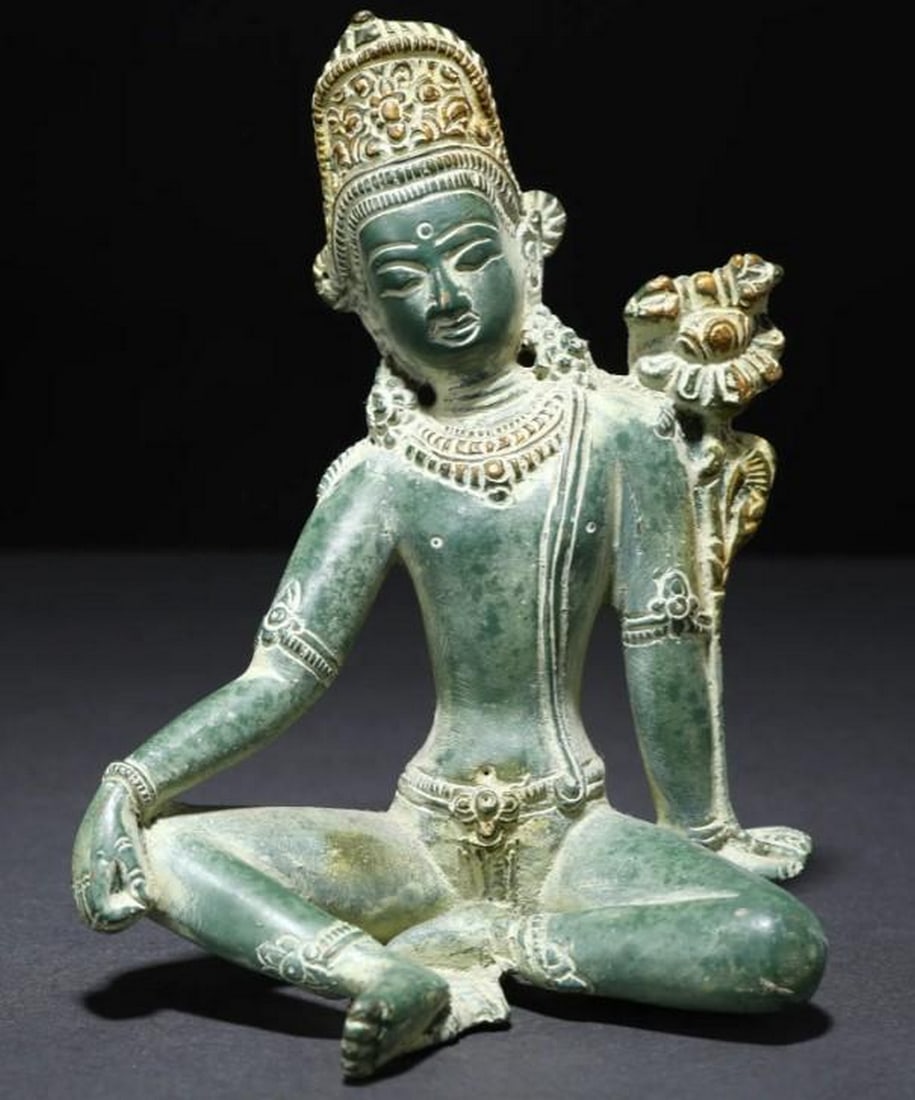 Tibetan Buddhist Deity Lord Indra In Brass: Tibetan Buddhist Deity Lord Indra In Brass This captivating brass sculpture features Lord Indra, the revered Tibetan Buddhist deity known as the king of gods and master of storms. Seated majestically 