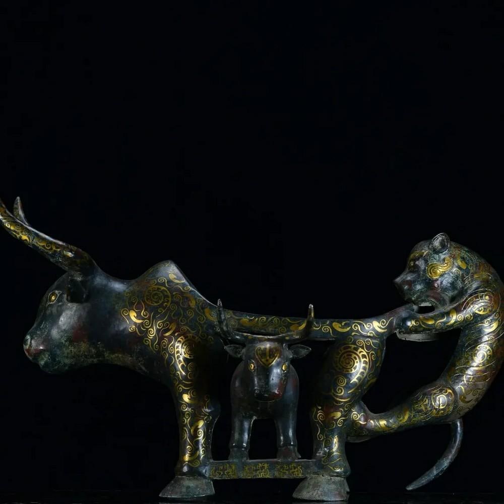 Antique Bronze Ox and Tiger Table Statue: Antique Bronze Ox and Tiger Table Statue This rare Chinese antique statue combines the strength of an ox with the fierce spirit of a tiger, symbolizing resilience and courage. Meticulously