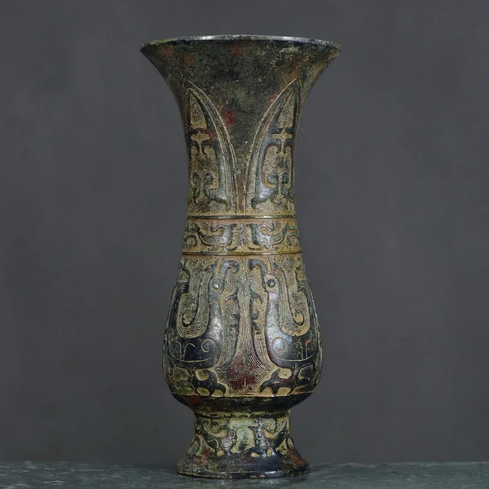 Antique Bronze Flower Goblet Statue: Antique Bronze Flower Goblet Statue This stunning Chinese antique features a hand-crafted bronze goblet adorned with exquisite floral motifs. Symbolizing beauty, growth, and prosperity, the detailed