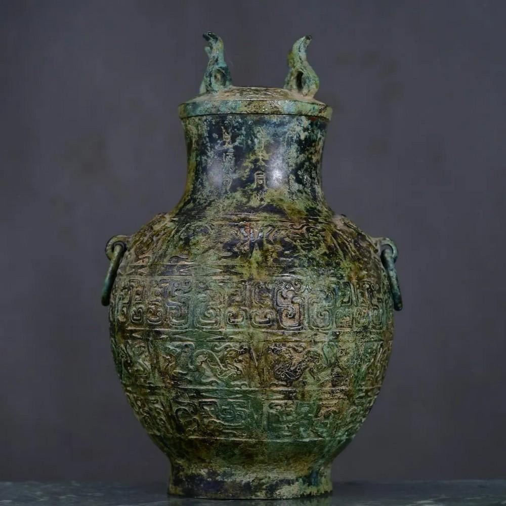 Antique Bronze Auspicious Beast Bottle Statue: Antique Bronze Auspicious Beast Bottle Statue This rare Chinese antique showcases a hand-crafted bronze bottle statue, adorned with the depiction of an auspicious beast. Known for its symbolic represe