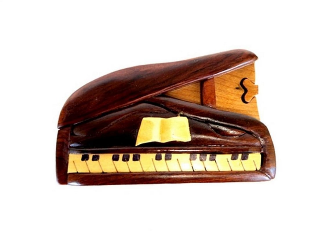 Mahogany Piano Keepsake Box: Mahogany Piano Keepsake Box This keepsake box is hand-carved from mahogany wood and features a piano design on the exterior, with a red velvet-lined interior for storing small items. The box opens