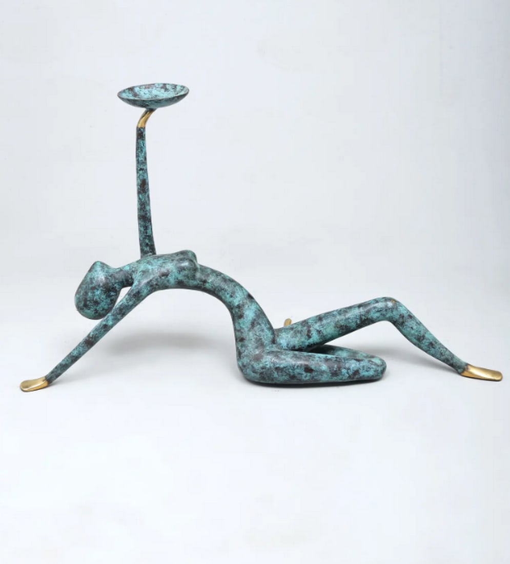 Brass Reclining Female Candle Holder – Lost Wax Casting: Brass Reclining Female Candle Holder – Lost Wax Casting This handcrafted brass candle holder features a graceful reclining female figure holding a bowl-shaped receptacle for a candle. Made using the