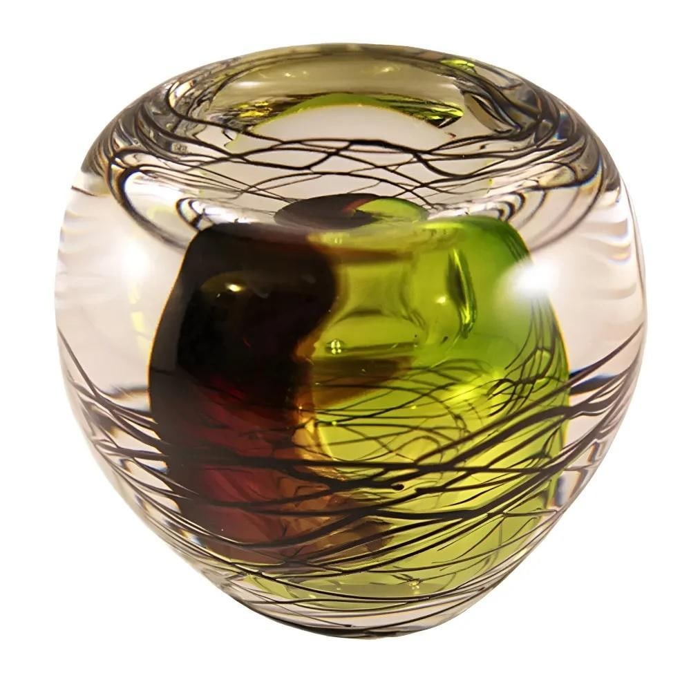 ‘Toffee Apple’ Round Glass Ornament by Remigijus Kriukas: ‘Toffee Apple’ Round Glass Ornament by Remigijus Kriukas Handcrafted by Lithuanian glass artist Remigijus Kriukas, the *Toffee Apple* ornament features a crystal-clear orb wrapped in fine black li