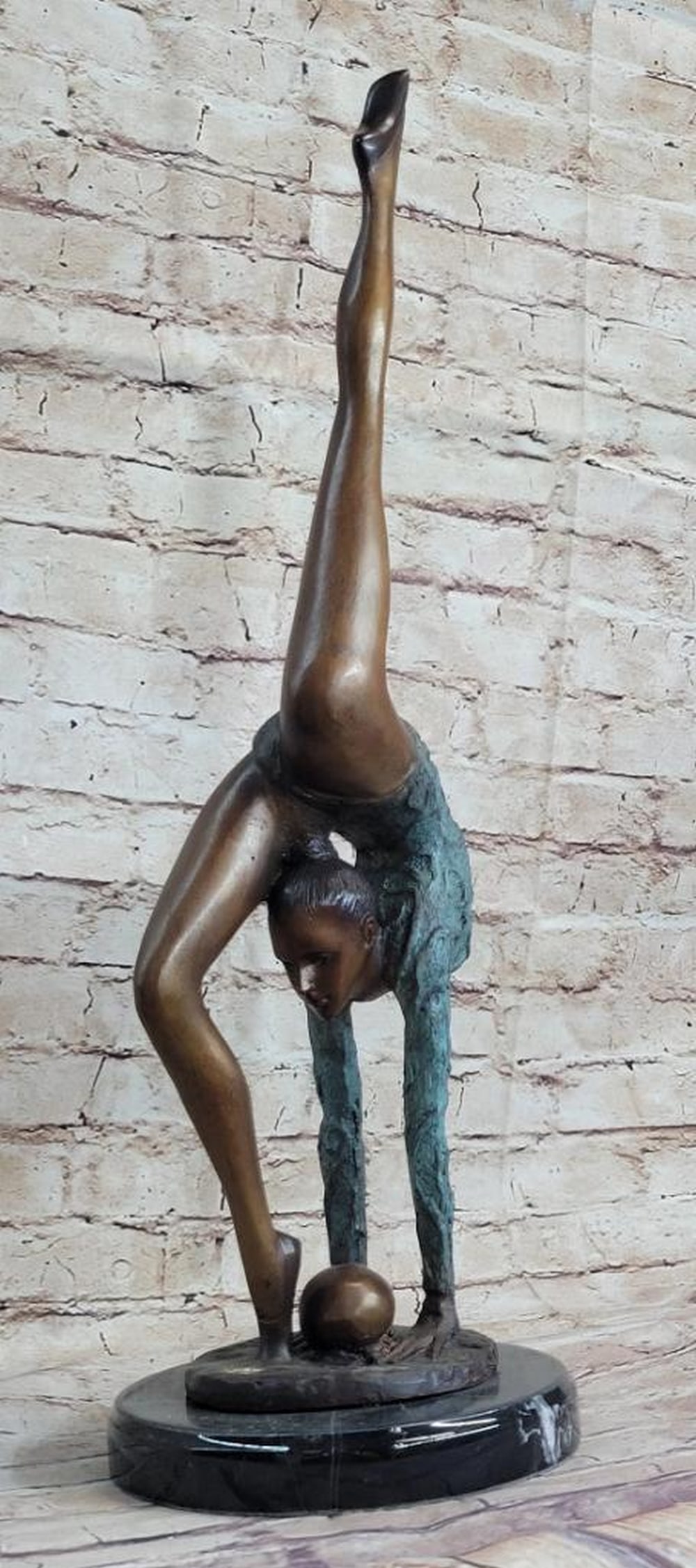 Acrobat Gymnast Bronze Sculpture - 22.5" x 7": Acrobat Gymnast Bronze Sculpture - 22.5" x 7" This floor gymnast shows off her skills as she does a perfect back bend and gracefully extends her leg straight up and vertically. She shows an am