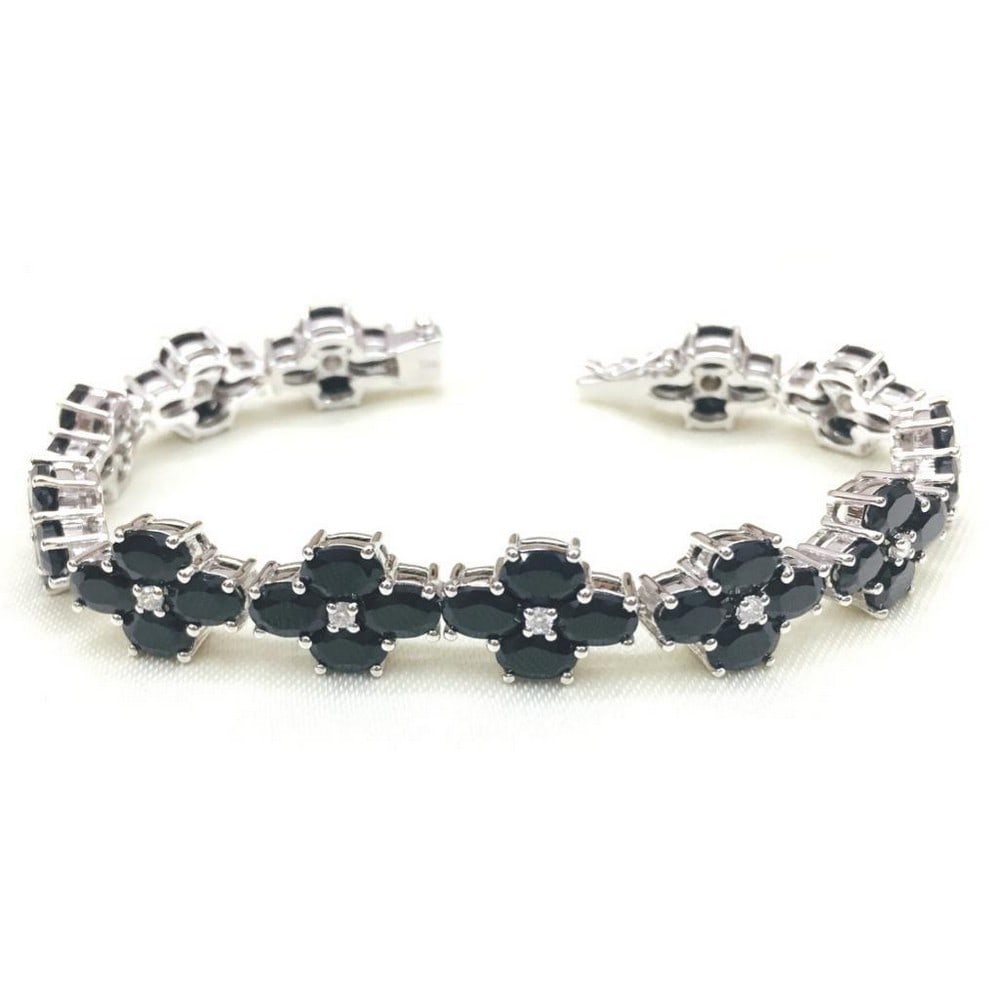 Black Spinel Studded Flower Bracelet: Black Spinel Studded Flower Bracelet This bracelet is 925 Sterling Silver and features black spinel in flower design with cubic zirconias. Gemstone Size: 6x4mm View Photos For Further Details.