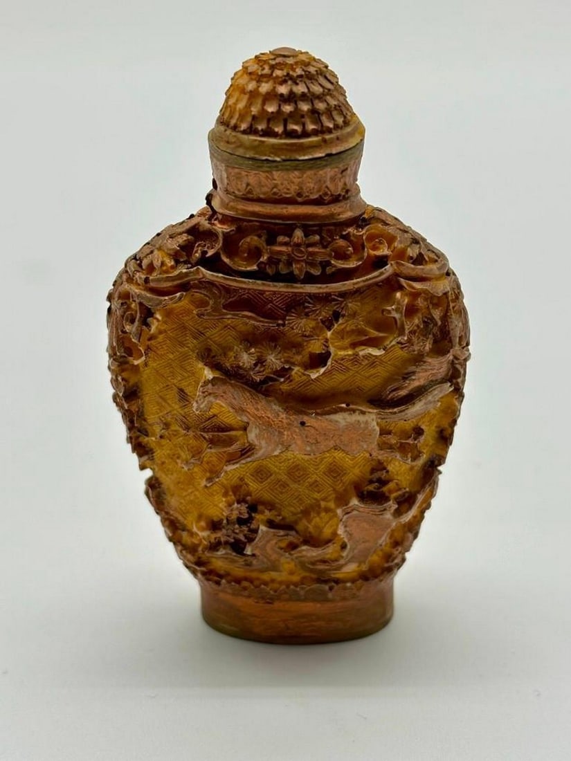 Hand Carved Chinese Cinnabar Style Snuff Bottle: Hand Carved Chinese Cinnabar Style Snuff Bottle This piece features a horse meticulously carved on both sides. The horse, a symbol of strength and vitality in many cultures, adds a touch of