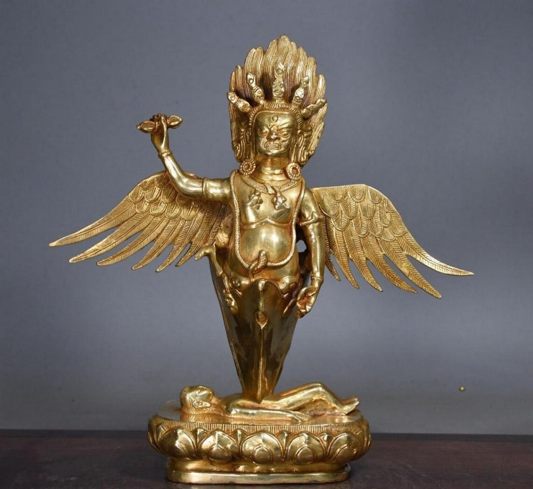 Gilded Copper Winged Dapeng Bird Buddha Statue: Gilded Copper Winged Dapeng Bird Buddha Statue This antique Buddha statue is a rare masterpiece of Chinese craftsmanship, meticulously handmade from pure copper and gilded with a luxurious golden fini