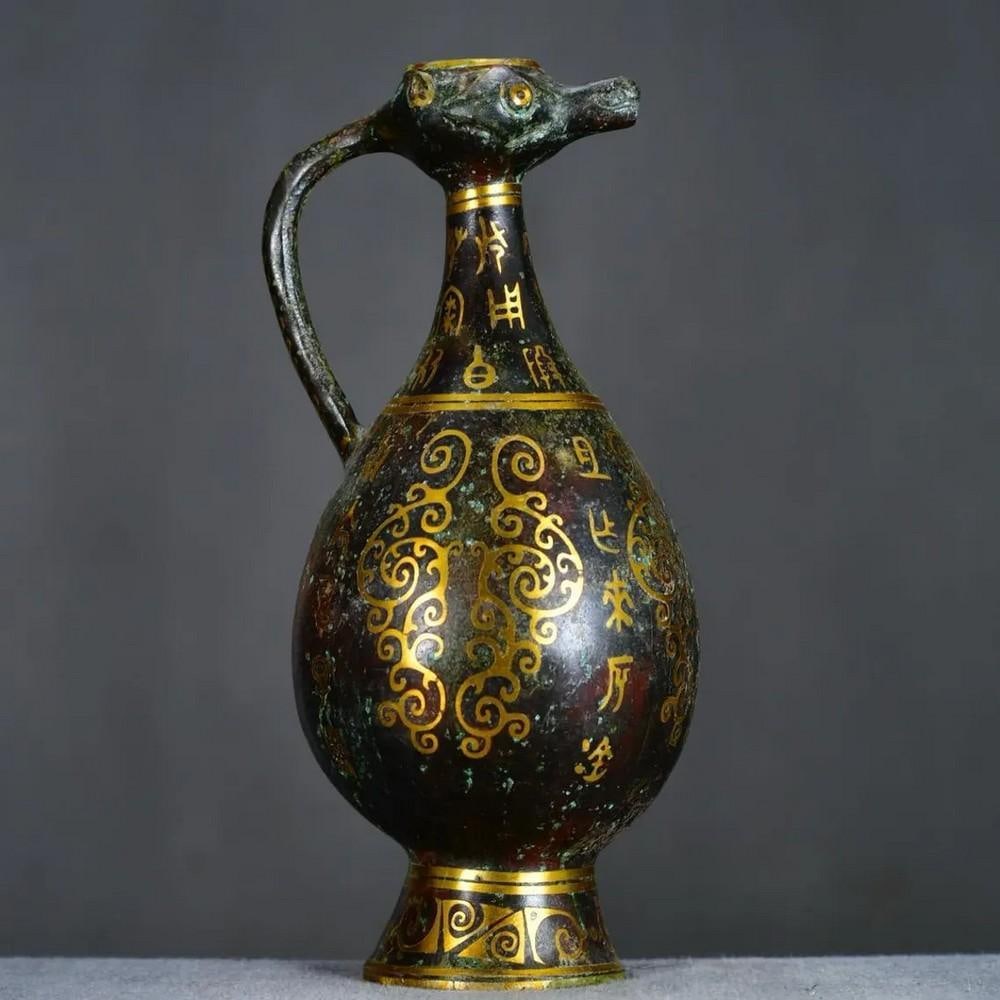 Antique Chinese Duck Headed Pot: Antique Chinese Duck Headed Pot This antique Chinese bronze pot features a unique duck-headed design, symbolizing grace and prosperity in Chinese culture. The detailed craftsmanship highlights the duc