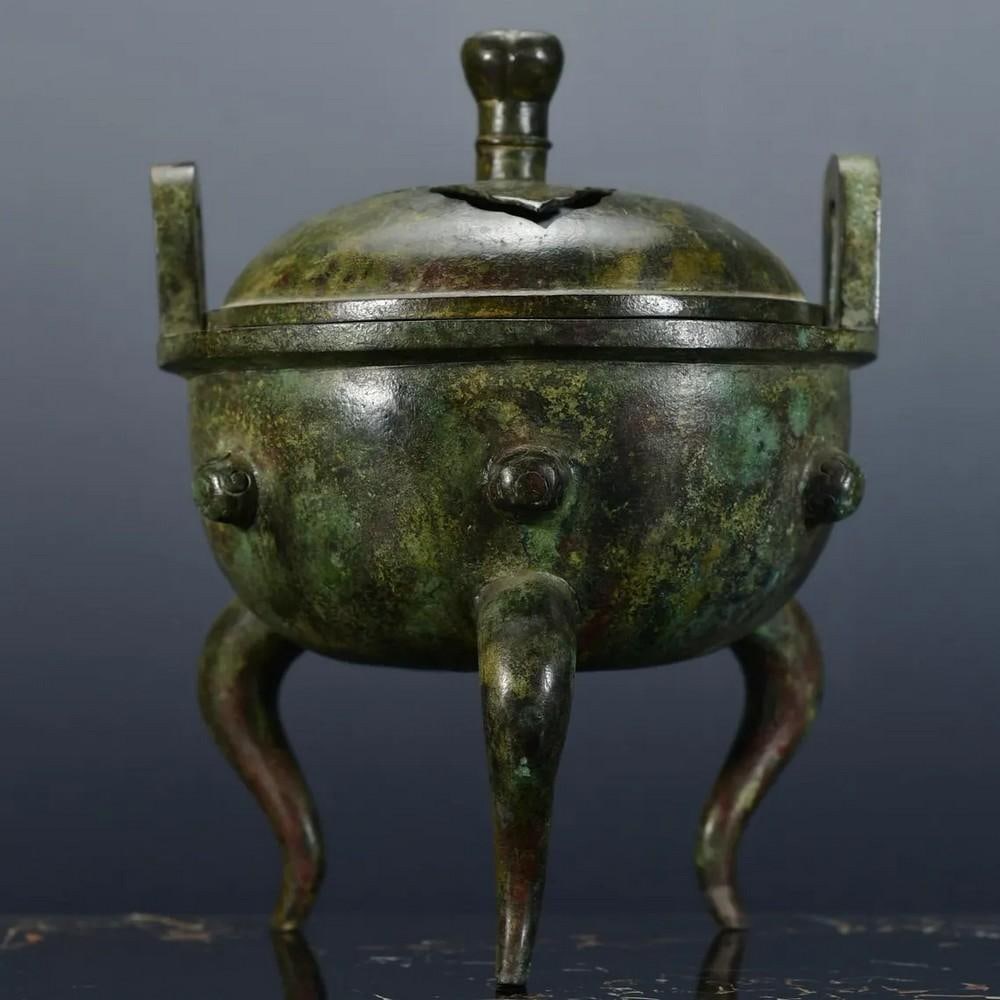 Chinese Handmade Bronze Hollow Tripod Statue: Chinese Handmade Bronze Hollow Tripod Statue This rare and finely crafted hollow tripod statue is a remarkable example of traditional Chinese artistry. Handcrafted with meticulous attention to detail,
