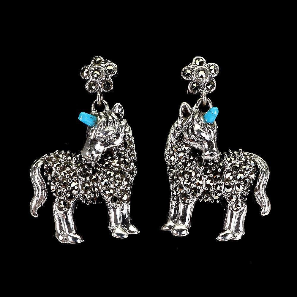 Stabilized Fancy Turquoise Marcasite Unicorn Earrings: Stabilized Fancy Turquoise Marcasite Unicorn Earrings This unique pair of earrings features a 925 sterling silver unicorn with a top rich blue fancy cabochon horn. This pair of earrings is a perfect