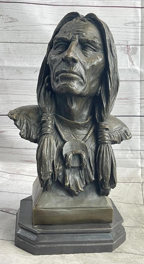 Native American Old Man Weathered Face Bronze Sculpture Bust On Marble Base: This is an exquisite bronze bust of a Native American warrior chief. He stares at the beholder, wild and bold, with an air of spiritual resilience. His hair is adorned with braids. He wears a custom J