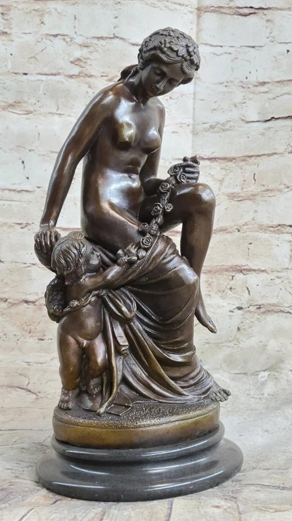 Sculpted Elegance Inspired Bronze Statue: Sculpted Elegance Inspired Bronze Statue A lovely young woman reclines, accompanied by her cherubic baby angel standing at her side, affectionately grasping onto her thigh. The admiration between them