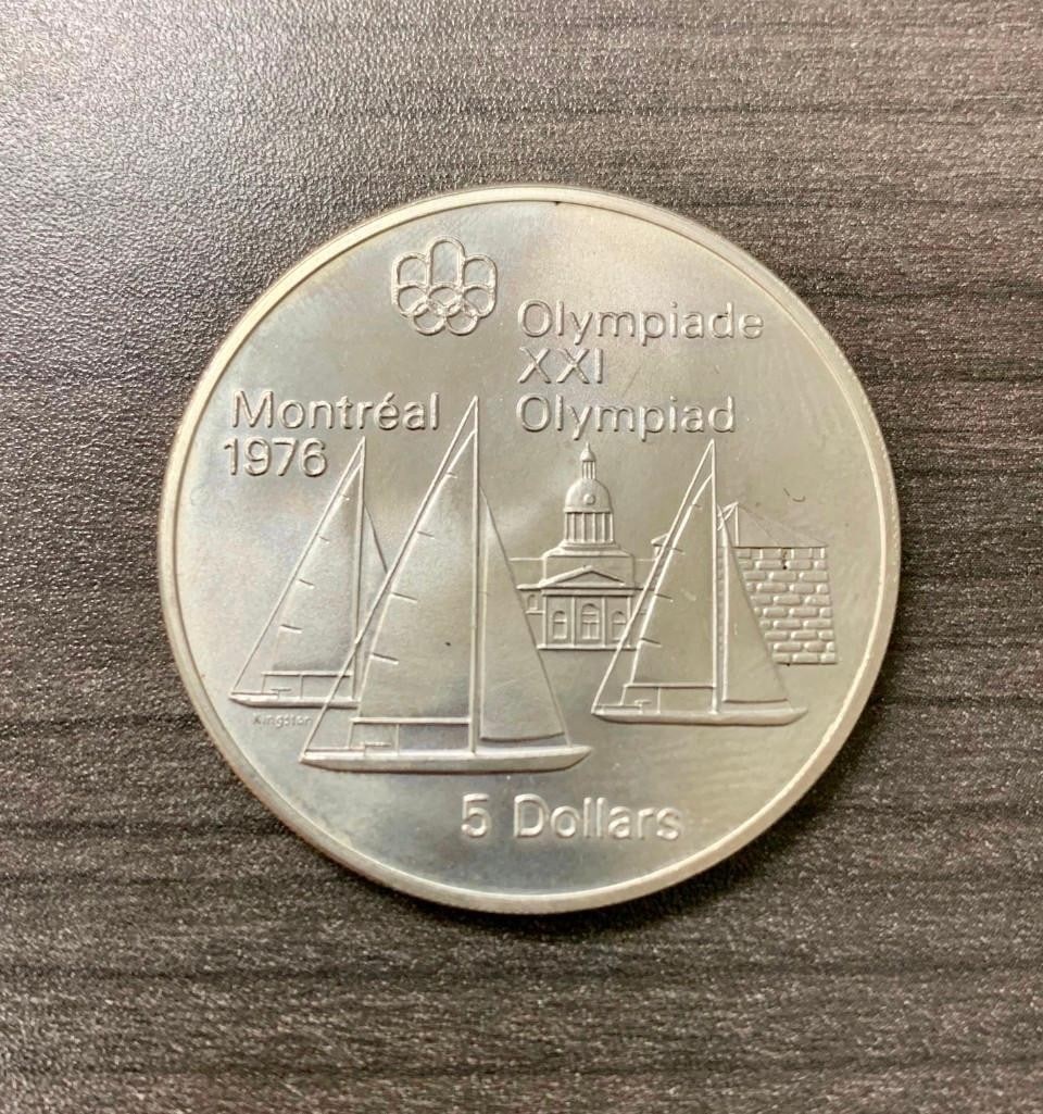 5 DOLLARS - ELIZABETH II KINGSTON AND SAILBOATS: Commemorative issue 1976 Olympics, Montreal Obverse Effigy of Queen Elizabeth II facing right. Lettering: ELIZABETH II CANADA 1973 Engraver: Arnold Machin Reverse Sail boats Lettering