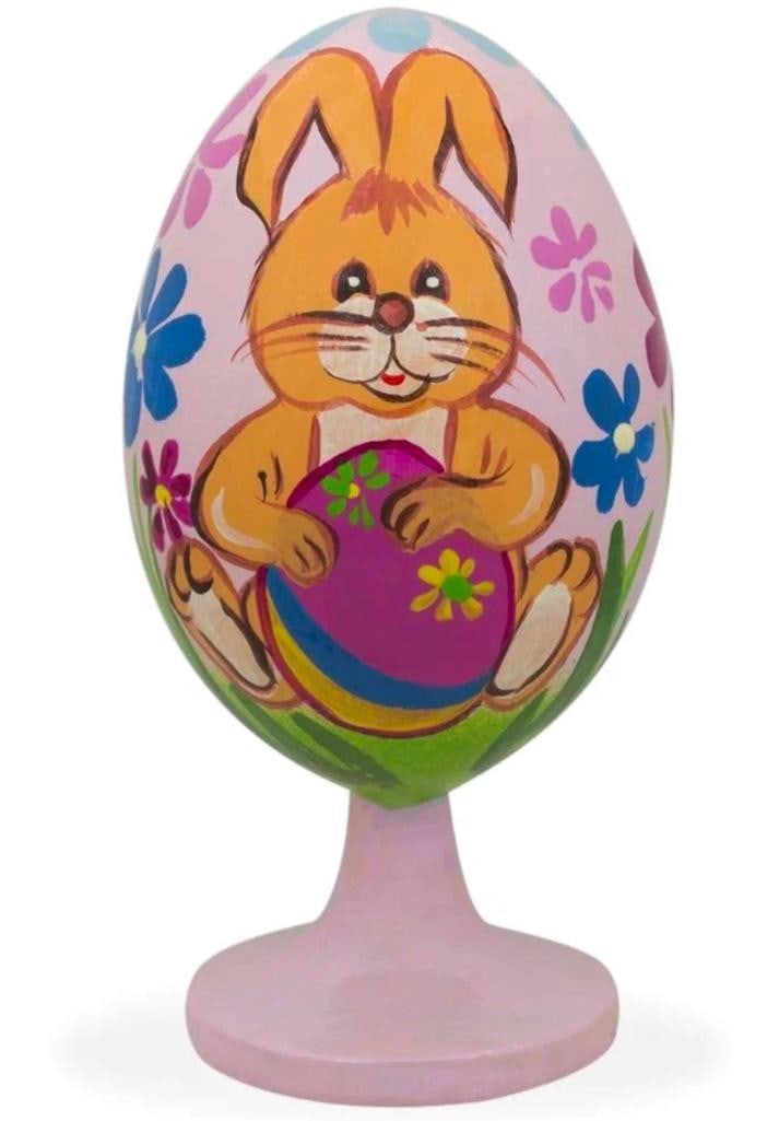 Lovable Bunny Decorating Easter Egg Wooden Figurine: Lovable Bunny Decorating Easter Egg Wooden Figurine. This adorable bunny decorating an Easter egg and colorful flowers are hand painted onto a wooden egg. This egg is 3.5 inches tall, hand painted, an