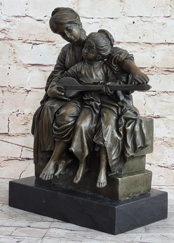 Mother & Child Strumming Guitar Bronze Sculpture: Mother & Child Strumming Guitar Bronze Sculpture A young girl sits against her mother as the mom teachers how to play the instrument. The young girl is eagerly fiddling with the strings as her mother 