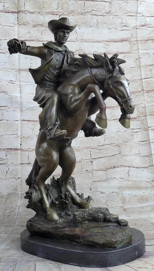 Remington Inspired Bronco Buster Bronze Sculpture - 20'' x 14'': Remington Inspired Bronco Buster Bronze Sculpture - 20x34 x 14x34 Experience the untamed spirit of the Wild West with this captivating bronze sculpture. A seasoned cowboy fearlessly rides his wild hor