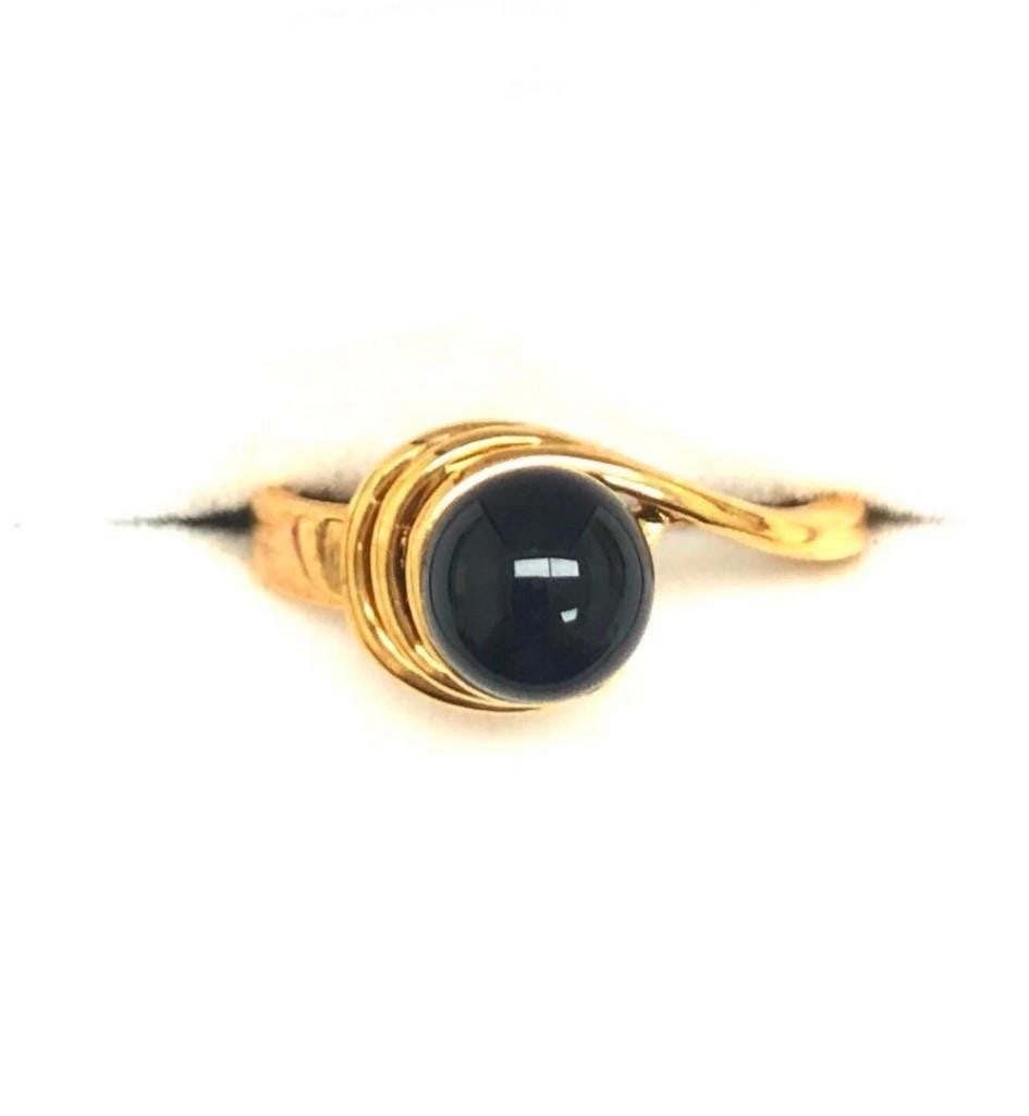 Onyx Gemstone In 18KTGP Yellow Gold Electroplate Finish Ring: Onyx Gemstone In 18KTGP Yellow Gold Electroplate Finish Ring. This elegant ring features a striking black onyx gemstone set in a polished 18KT yellow gold electroplated band. The deep, glossy onyx