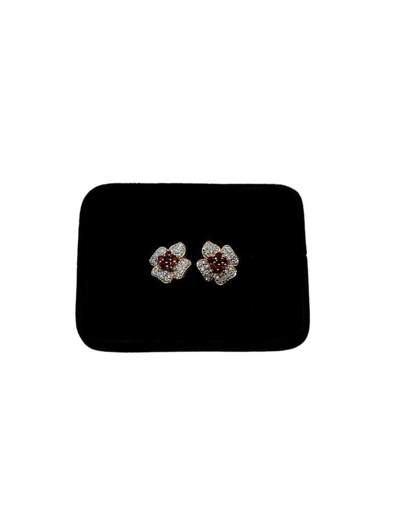 Ruby Blossom Austrian Crystal Gold Plated Earrings: Ruby Blossom Austrian Crystal Gold Plated Earrings These exquisite earrings feature a stunning ruby-red blossom design, adorned with sparkling Austrian crystals. The vibrant crystals catch the light