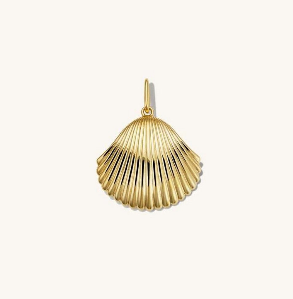 Gold Vermeil Sunkissed Shell Pendant: Gold Vermeil Sunkissed Shell Pendant As if you picked it right off the beach - minus the sand. The Sunkissed Shell Pendant is made to complement your favorite necklaces, hoops, and bags, adding a hint