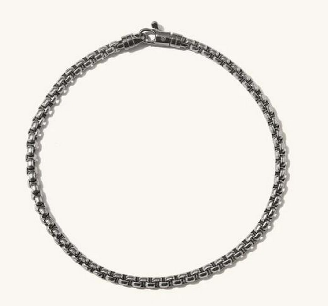 Titan Round Link Bracelet: Titan Round Link Bracelet With A Sterling Silver Clasp. This is a striking bracelet crafted from durable titanium, featuring a sleek round box chain design. Its minimalist yet bold aesthetic offers a