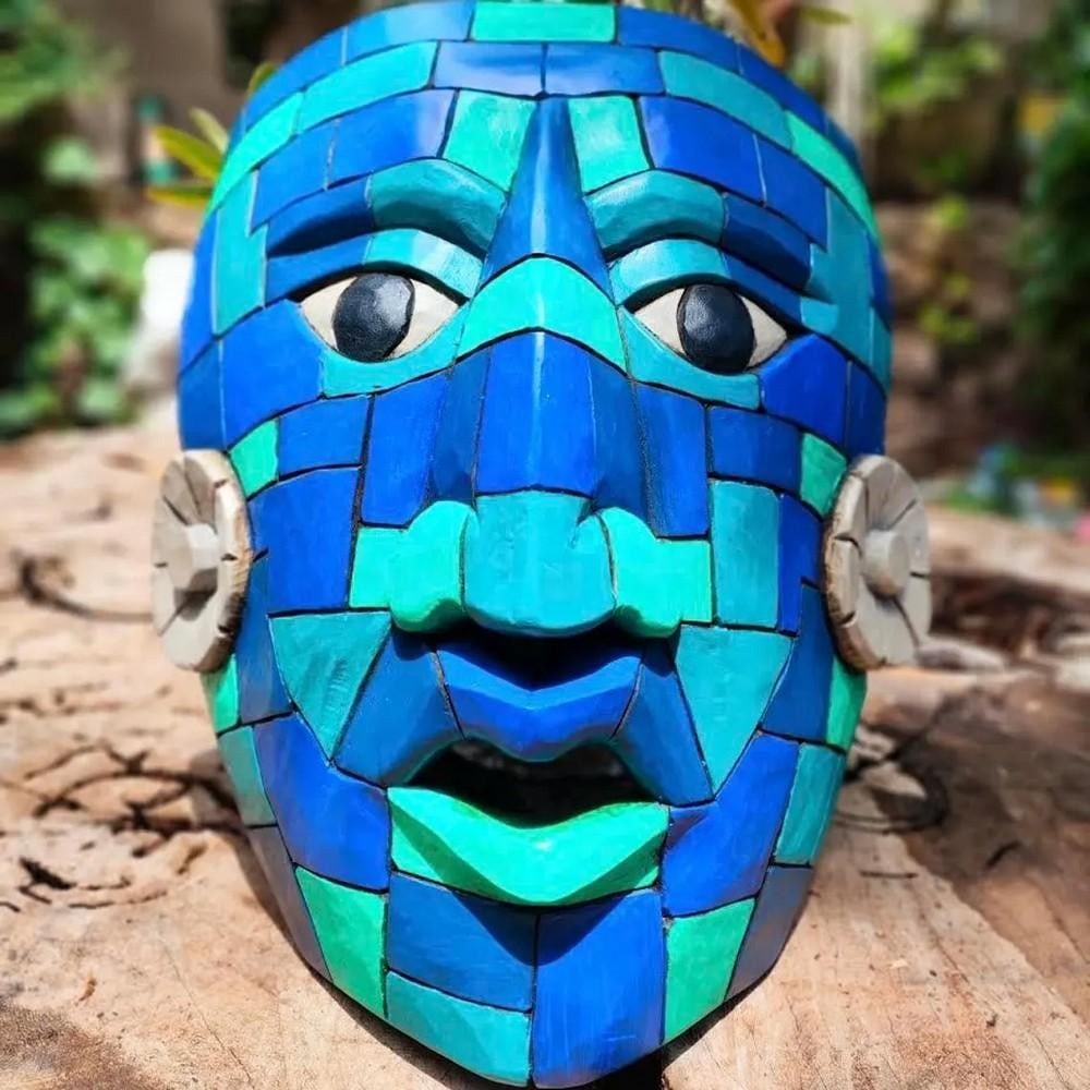 Hand Crafted King Pakal Cedar Mask: Hand Crafted King Pakal Cedar Mask This handcrafted cedar wood mask depicts King Pakal with a stylized 3D carved design, featuring detailed facial elements and traditional ornamental features. The com
