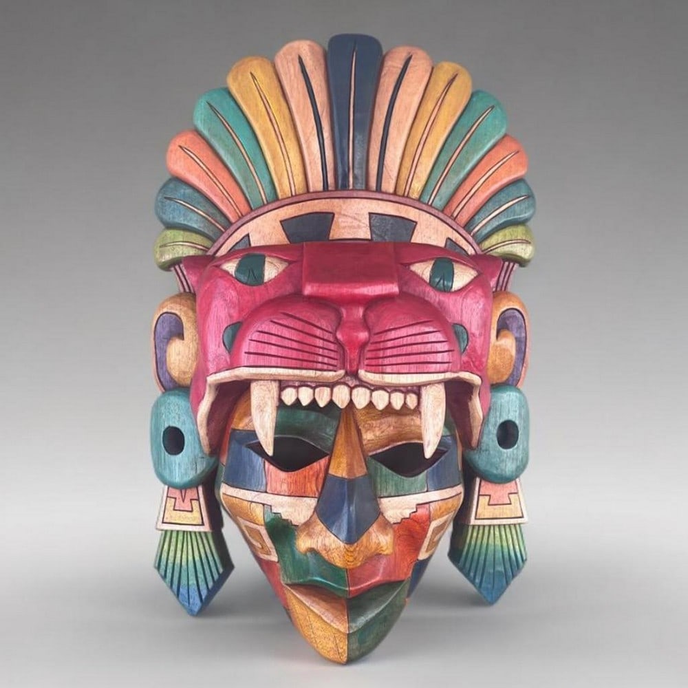 Jaguar Warrior Hand-Carved Wooden Mask: Jaguar Warrior Hand-Carved Wooden Mask This cedar wood mask depicts a Jaguar Warrior inspired by Mayan and Aztec traditions, featuring detailed carvings and vibrant colors. The design includes a jagua