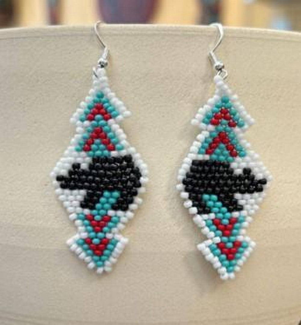 Spirit of the Bear Earrings: Spirit of the Bear Earrings The Spirit of the Bear Earrings capture the strength and wisdom of the wild. Handcrafted with intricate beading, these earrings feature a bold bear design, symbolizing