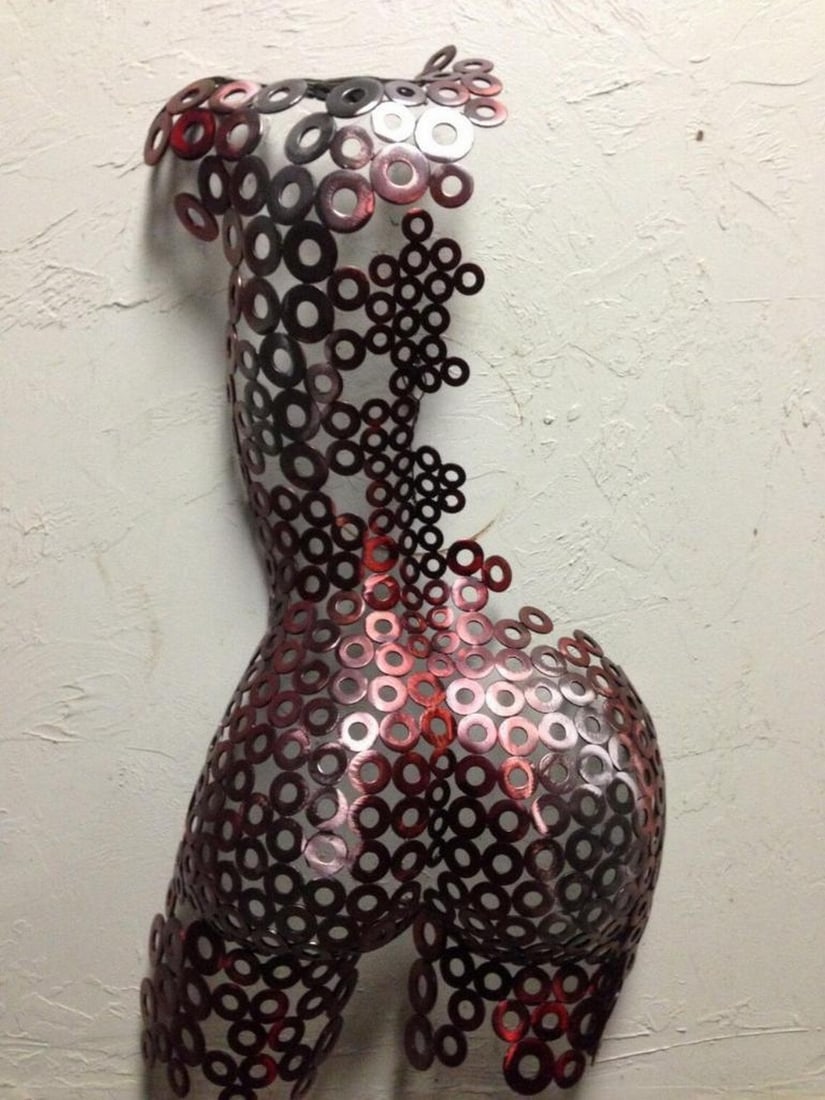 Fractured Elegance Metal Sculpture: Fractured Elegance Metal Sculpture This striking 12" female torso sculpture embodies strength and transformation, meticulously hand-formed and welded with expert craftsmanship. The intricate textu