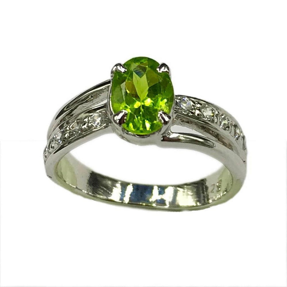 Sterling Silver Peridot Stone Ring: Sterling Silver Peridot Stone Ring This ring is studded with zirconias and a beautiful peridot gemstone. Inner Diameter: 17.6mm View Photos For Further Details