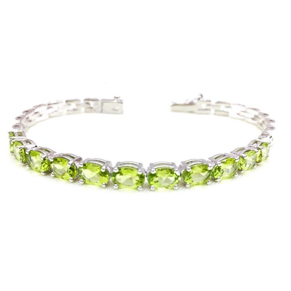 Green Peridot Studded Bracelet: Green Peridot Studded Bracelet This 925 Sterling Silver bracelet features gorgeous green peridot faceted oval gemstones. Size of Gemstones: 6x8mm View Photos For Further Details.