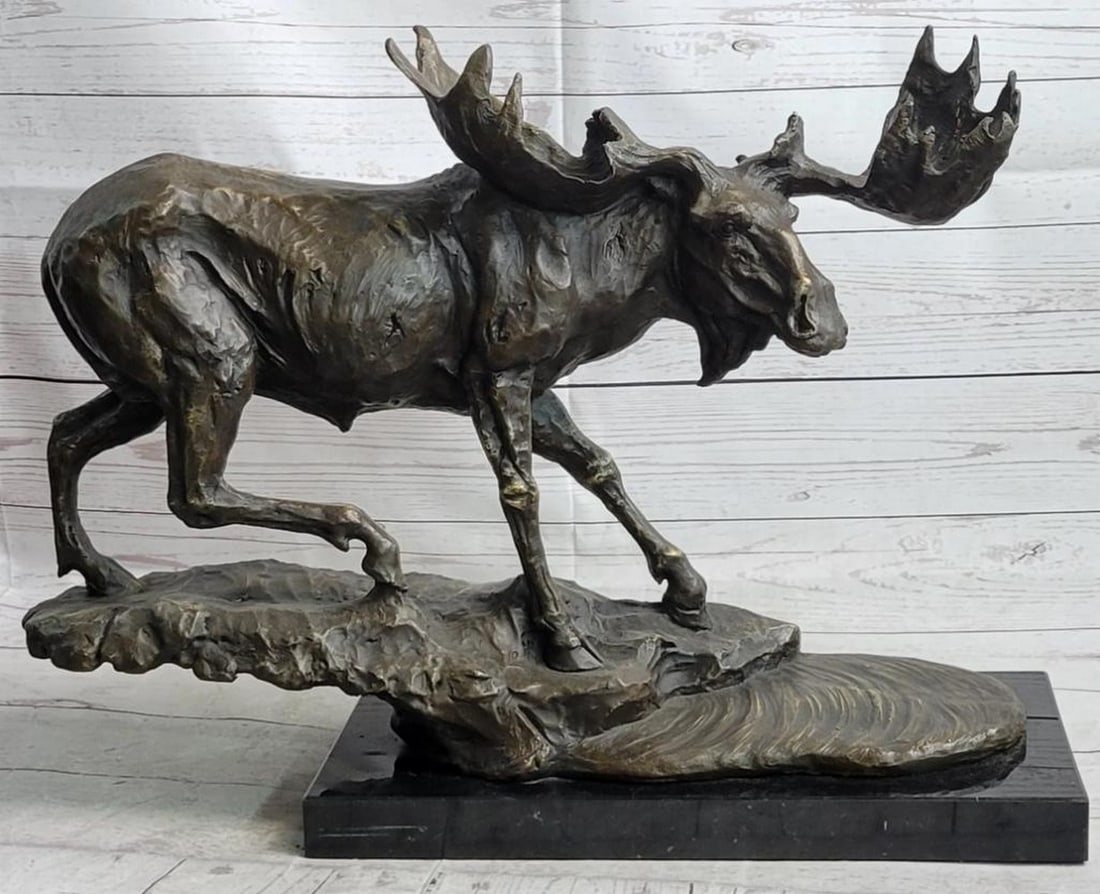 Signed Bugatti Inspired Large Moose Bronze Sculpture - 16'' x 23'': Signed Bugatti Inspired Large Moose Bronze Sculpture - 16" x 23" This bronze sculpture depicts a moose eating the wet grass from a lake. He bends down into the water keeping his hind legs on h