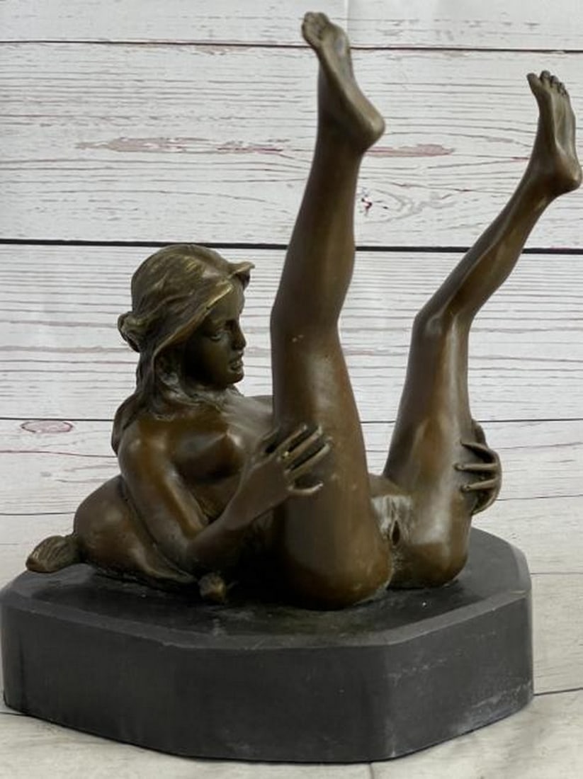 Open Reverie Bronze Sculpture: Open Reverie Bronze Sculpture This powerful bronze sculpture bearing the signature of artist Nino Oliviero captures a deeply intimate moment of a nude woman lying down, holding her legs up and open. T