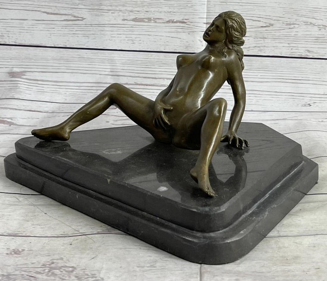 The Temptress Bronze Sculpture Signed by Nino Oliviono - 7'' x 12'': The Temptress Bronze Sculpture Signed by Nino Oliviono - 7" x 12" This provocative sculpture portrays a seductive woman sitting on the ground, legs wide open, revealing the mysteries of her wo