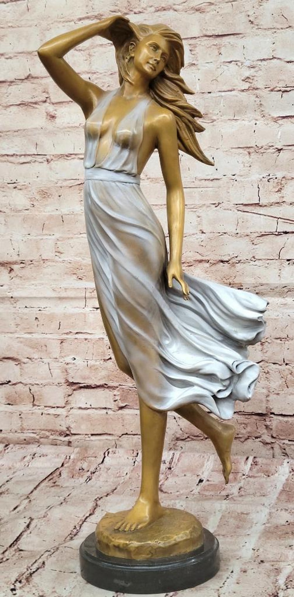 Bronze Sculpture Elegant Woman in the Wind - 24'' x 8'': Bronze Sculpture Elegant Woman in the Wind - 24" x 8" This exquisite bronze sculpture captures the elegance and movement of a woman as the wind lifts her flowing skirt. Her poised stance conve
