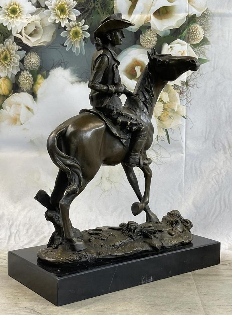 Bronze Western Sculpture Cowboy on Horseback Statue Figure 14'' x 11'': It's the Wild Wild West! This gunslinger, comfortable on his rearing horse, looks over the horse's neck to watch ahead for his enemy. He's ready to fire his weapon if need be as he travels hurriedly t