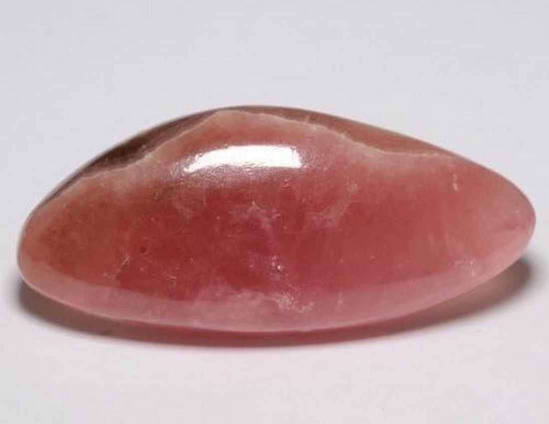 28.02 ct Fancy Natural Multicolor Rhodochrosite: 28.02 ct Fancy Natural Multicolor Rhodochrosite This natural 28.02-carat rhodochrosite from South Africa is cut in a unique fancy cabochon shape, showcasing a striking multicolor pattern with transluc