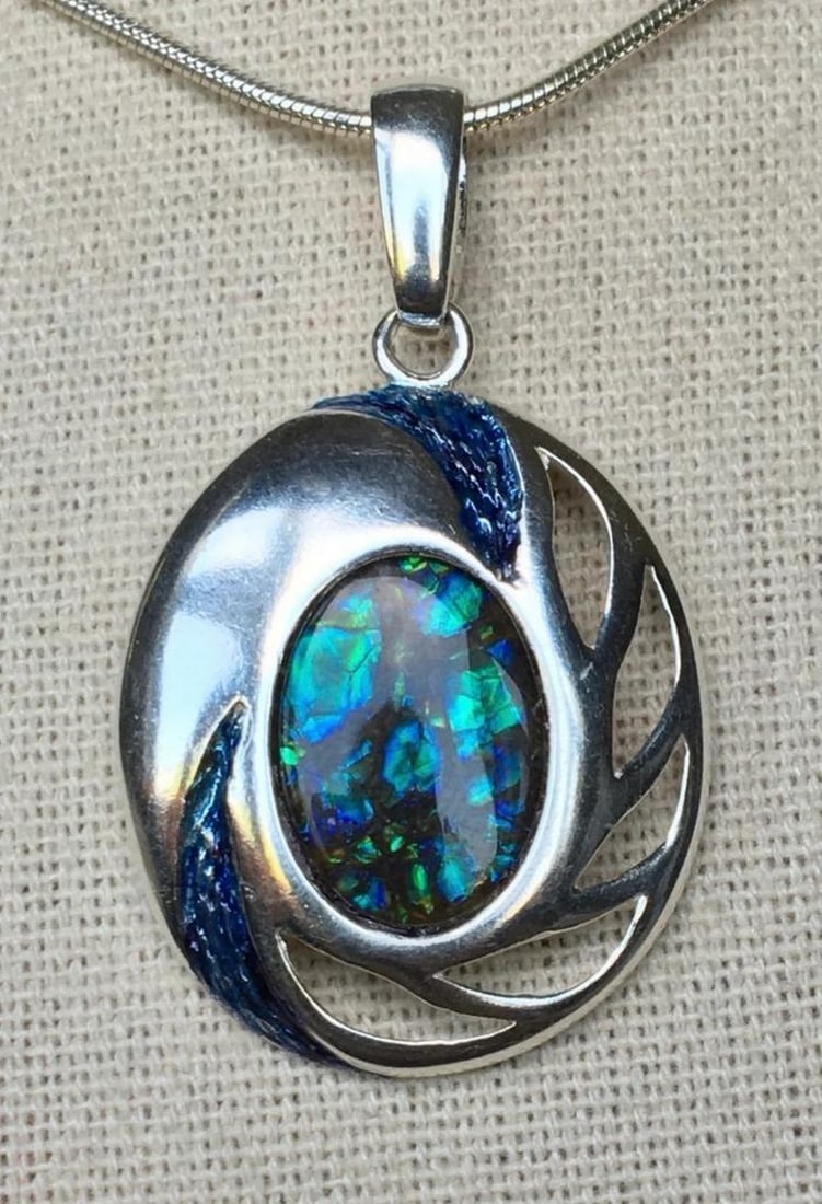 Solid Sterling Dragon Skin Ammolite Necklace Pendant: Solid Sterling Dragon Skin Ammolite Necklace Pendant This ammolite pendant is set in a substantial sterling silver setting, measuring 3.8cm x 2.3cm, with a 14mm x 10mm quartz-capped triplet gemstone i